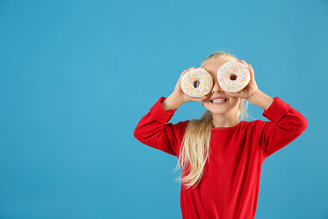 Cute little girl with donuts